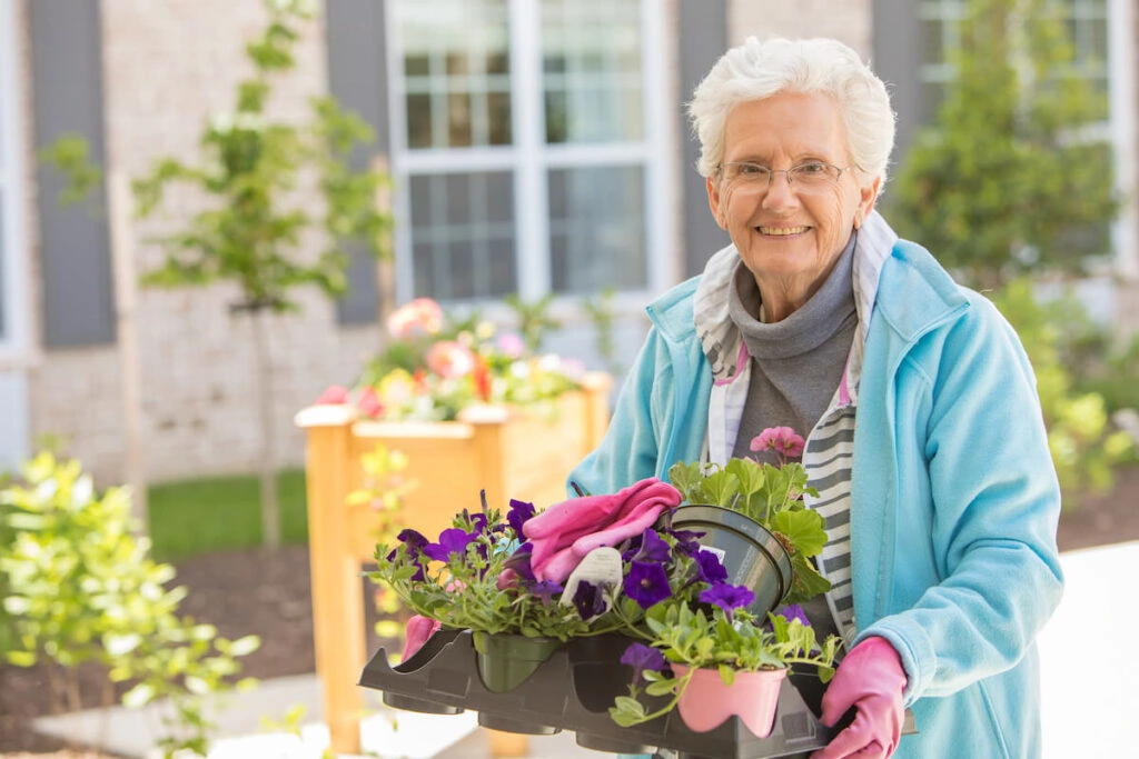 senior woman gardening at an independent living facility